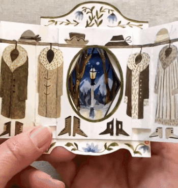 a gif of the inside of a tunnel book showing its three-dimensional scene inside of the winter scene and lamp post through the wardrobe in Narnia