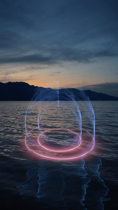 a gift of light projecting onto the surface of water in the desert in blue and pink beams