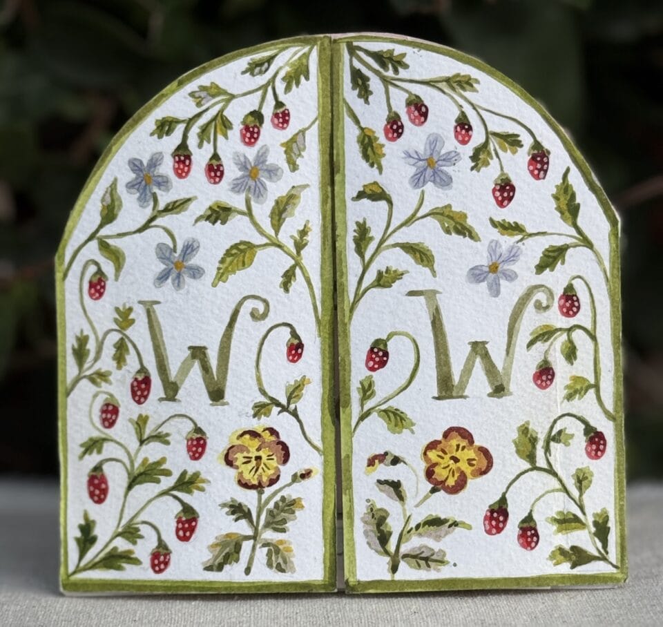 the exterior of a tunnel book, shaped like two large doors, which can be opened to reveal a narrative inside