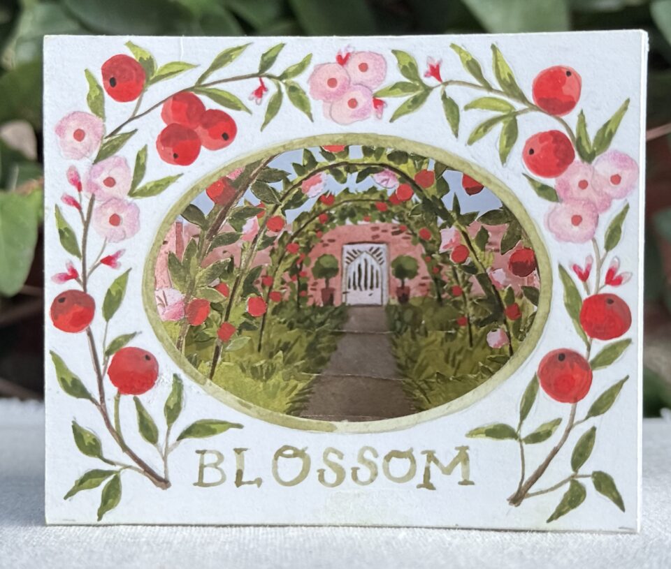 a tunnel book showing a scene of a garden through an oval aperture, labeled with the word "blossom"