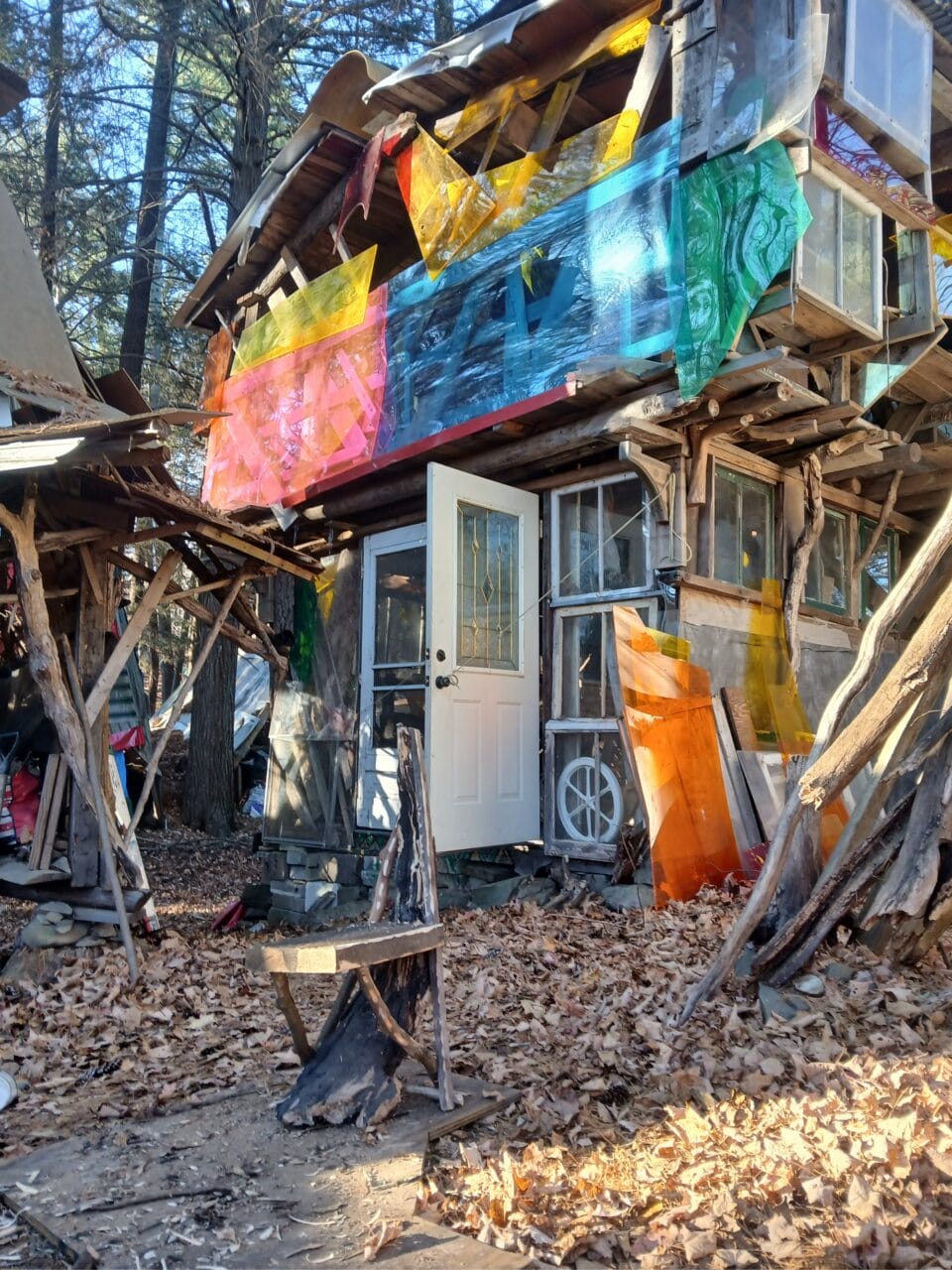 a hand-built cabin or shed-like structure, part of "B-Home," a collection of intuitively built structures from salvaged materials