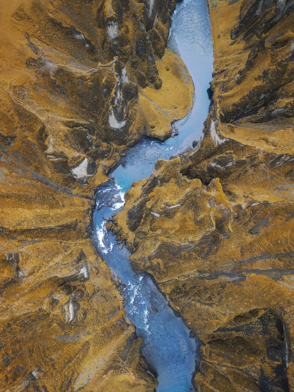 an aerial photo of a meandering river situated between mountains in Iceland