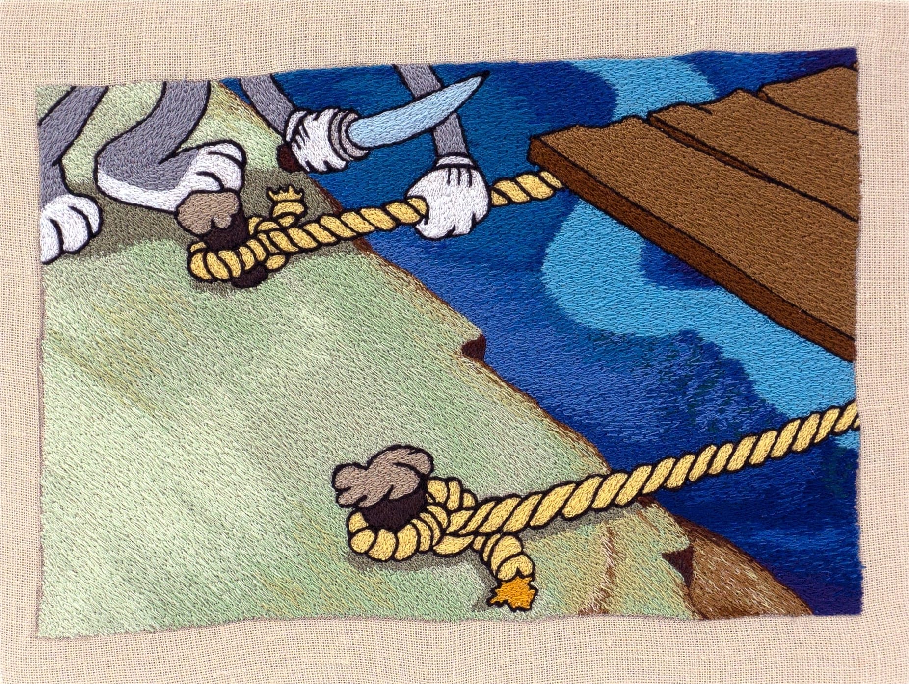 an embroidery of a cartoon figure cutting rope from a tied barge